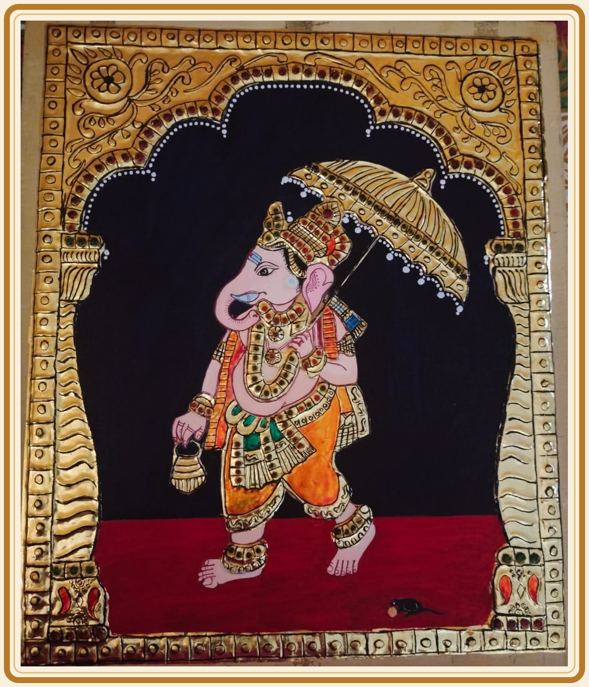 A devotional painting shown in its ornate gold frame